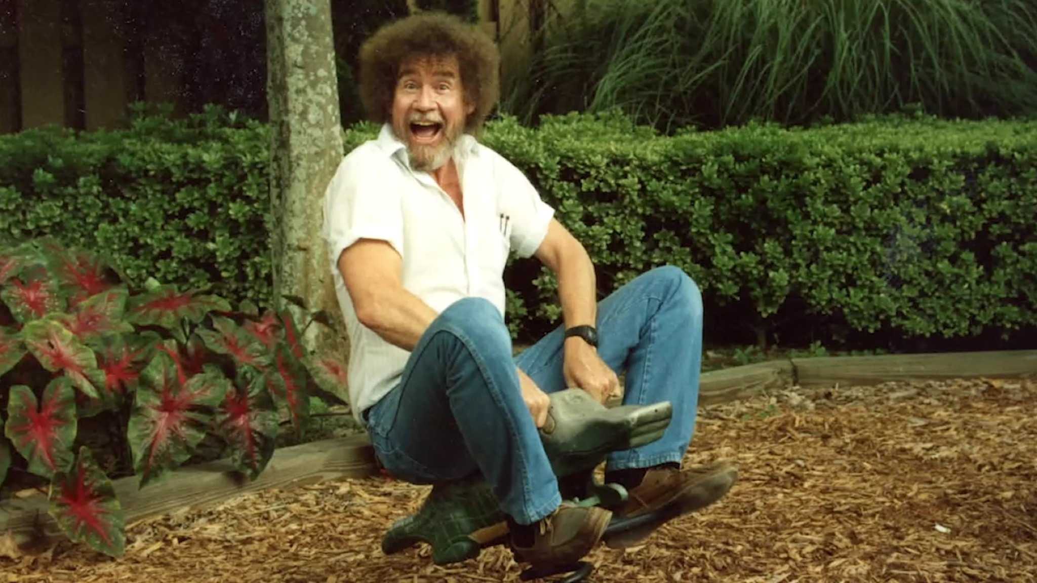 A photograph of Bob Ross playing on a childrens playground